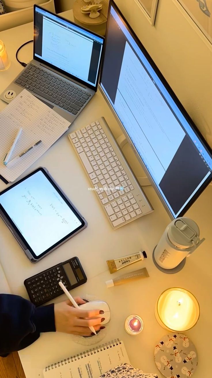 This may contain: a person sitting at a desk with two laptops and three computers on it,