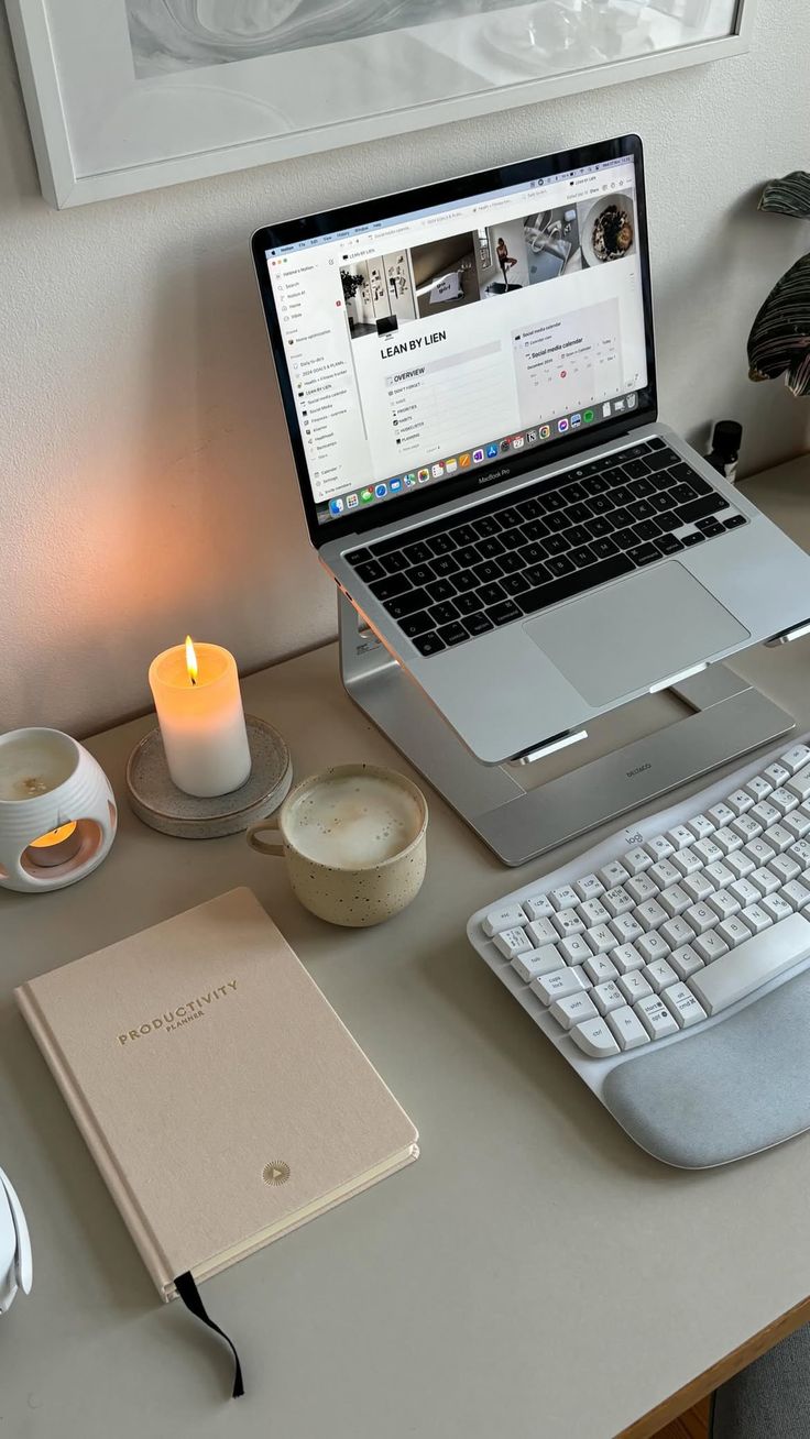 This may contain: an open laptop computer sitting on top of a desk next to a keyboard and mouse