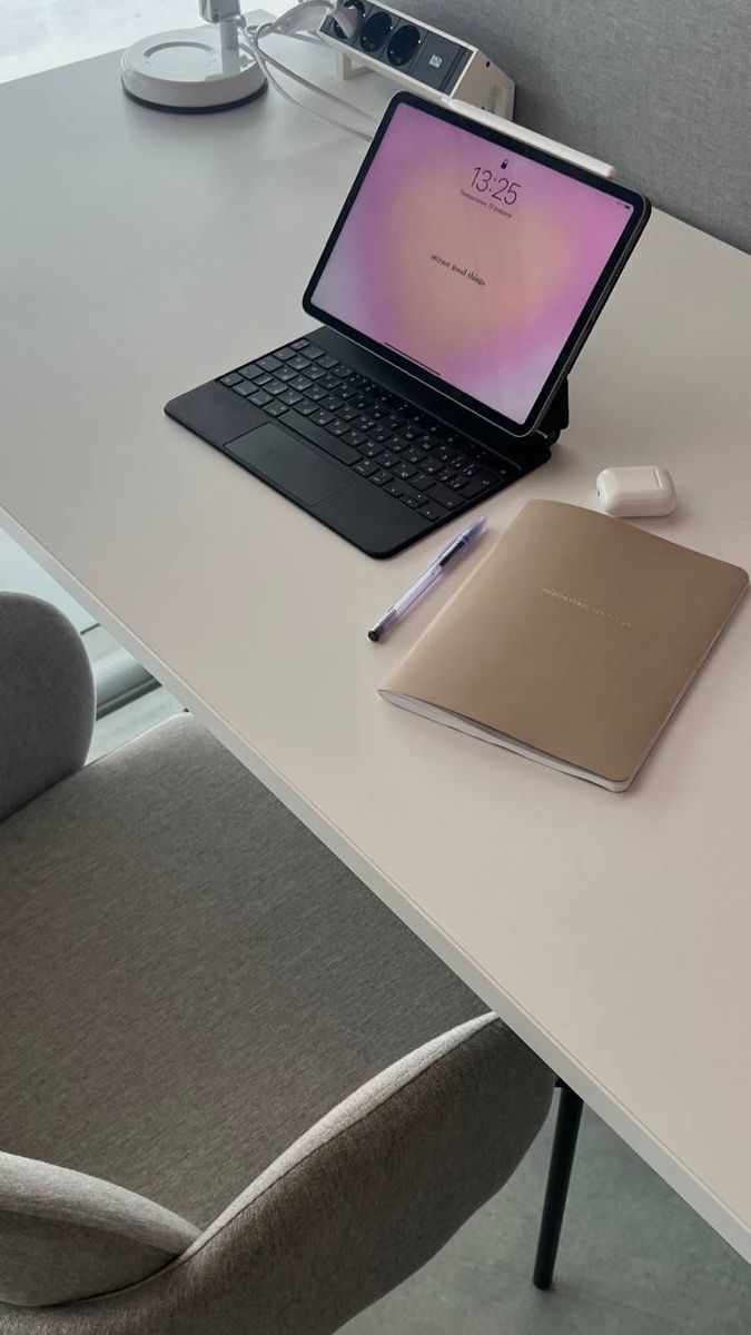 This may contain: an open laptop computer sitting on top of a white desk